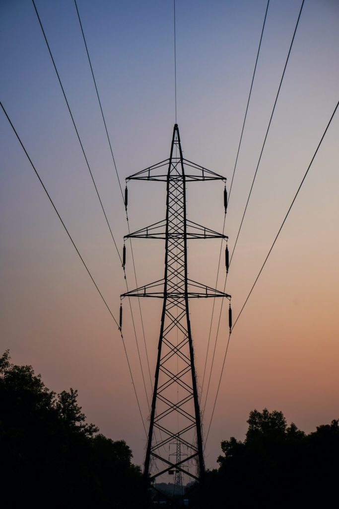 silhouette-of-a-power-pylon-against-a-twilight-sky-qjdqa7tlbqc